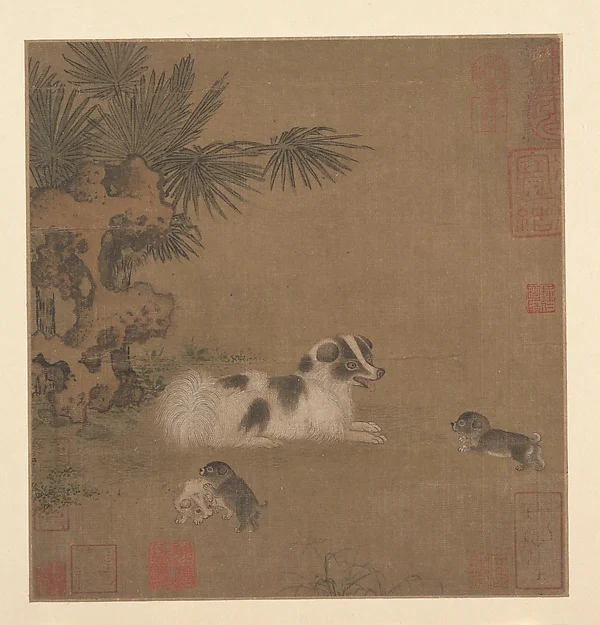 Puppies Playing beside a Palm Tree and Garden Rock — Unidentified artist